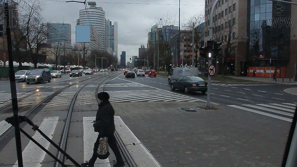 In this situation, should the tram driver wait until the pedestrian leaves the crossing?