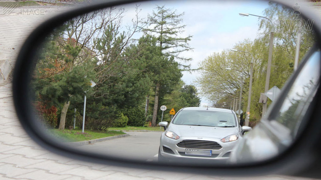 A properly adjusted external mirror on a passenger car shows: