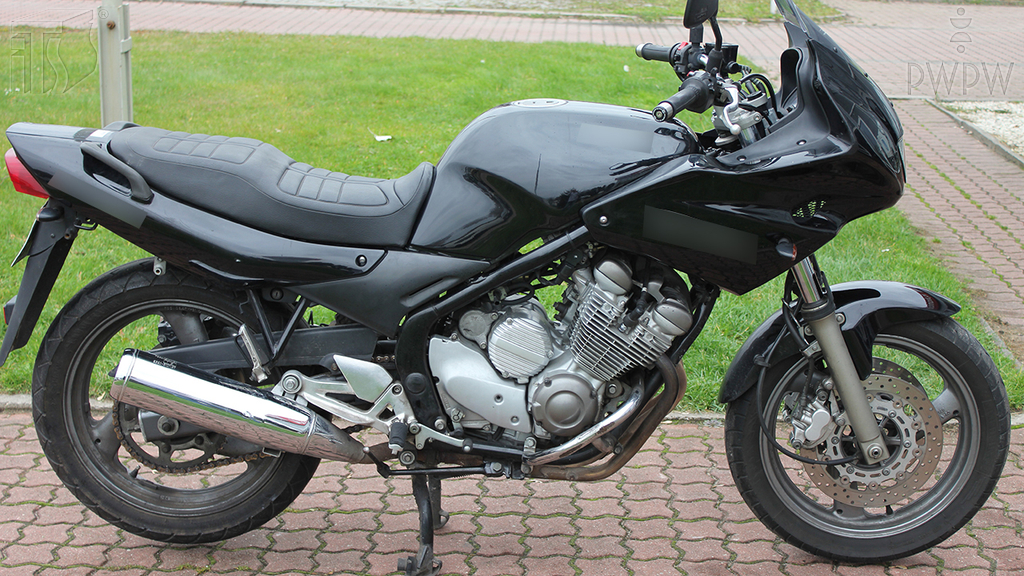 What must you not allow a passenger to do when you transport him on a motorcycle?