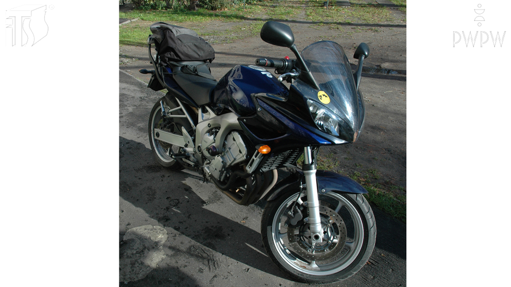 How can you place a load transported on a motorcycle?