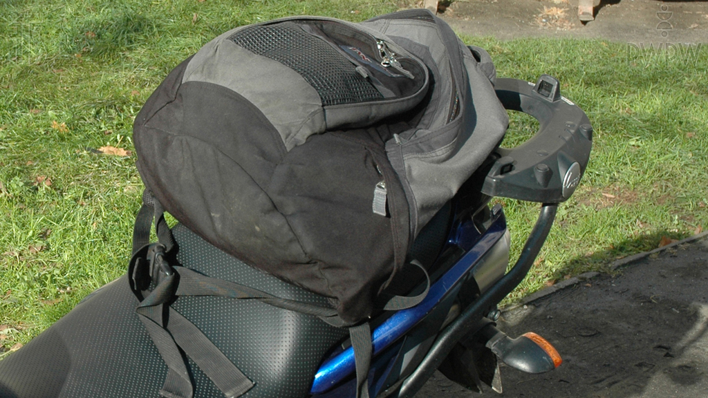 How can you place a load transported on a moped?