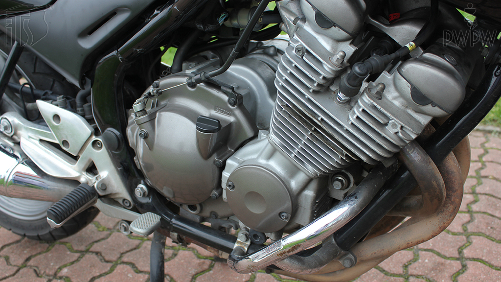 What should you do before you check the level of oil in the engine?