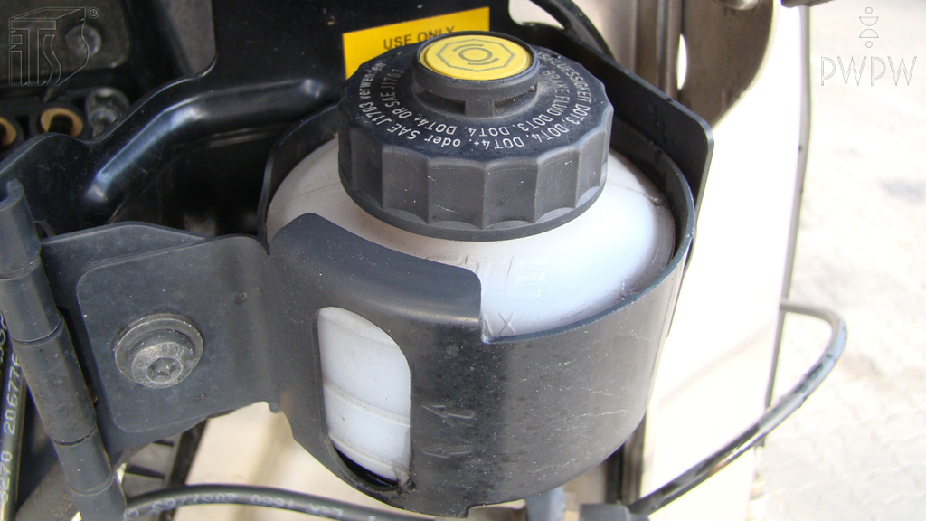 When must you check the level of the brake fluid?