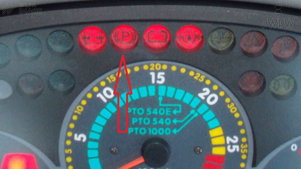 What does the activated control lamp indicated in the photo by the red arrow signal?