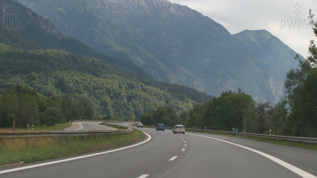 How should you proceed when driving a loaded truck downhill?