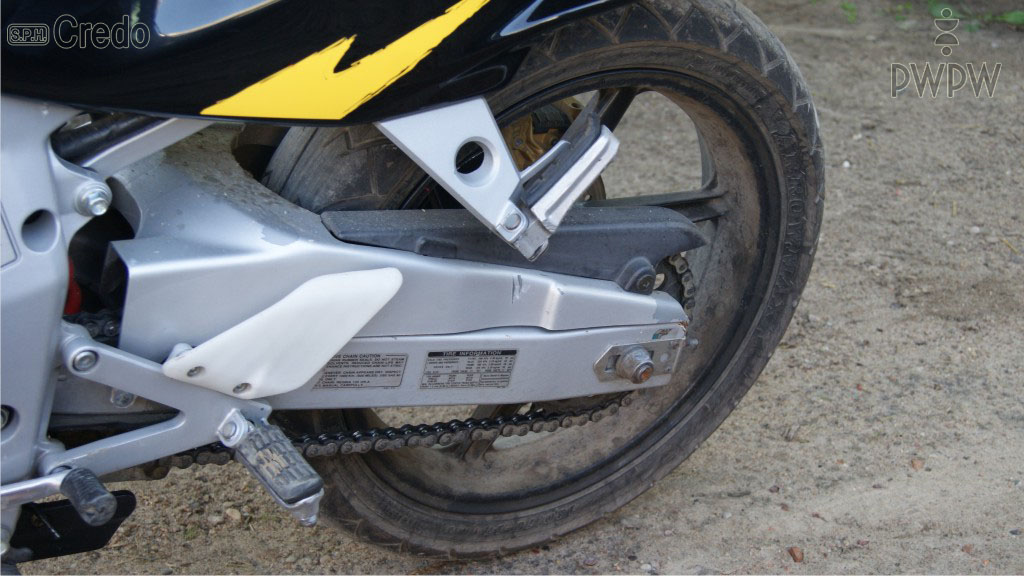 You are driving a motorcycle in the rain. How should you react when you notice that the rear tyre of your vehicle is losing grip?