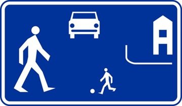 On a road designated in this manner, does an individual using a mobility aid have priority over vehicles?