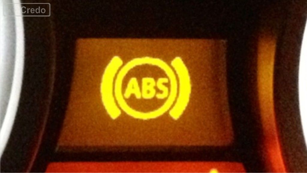 How do you effectively stop a vehicle with an ABS?