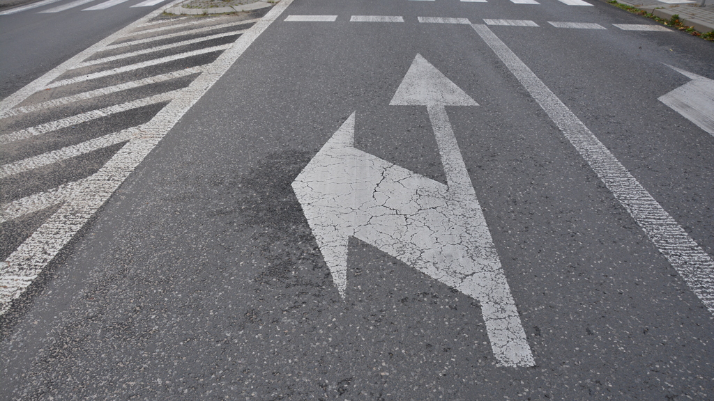 Is it permitted to drive straight ahead or right from a lane with the visible horizontal sign?