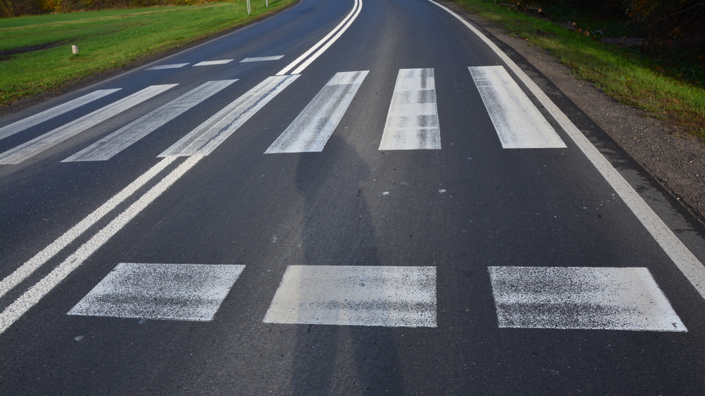 Does the visible line consisting of rectangles indicate a place of absolute stop before the pedestrian crossing?