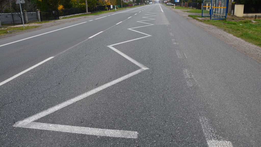 Does the visible "bus stop line" signify a roadway on which driving is prohibited?