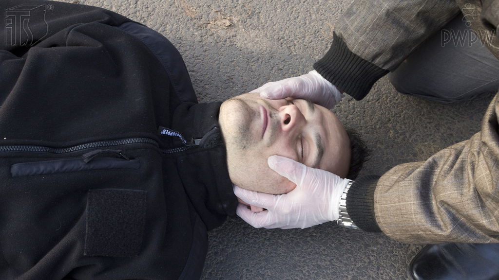 How long should you stabilize the head of a trauma patient manually?