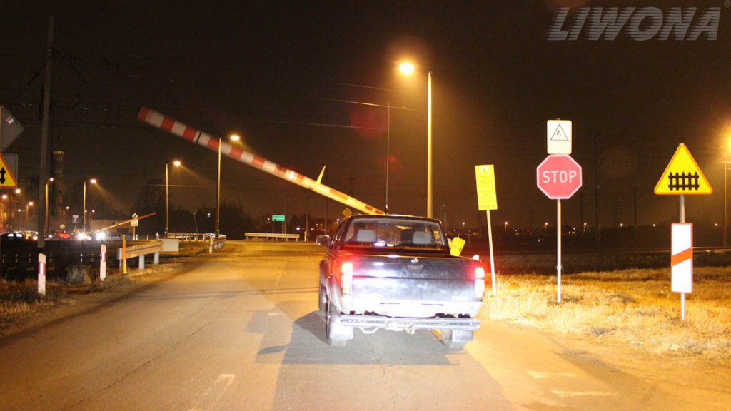 Are you permitted to enter the level crossing while the barrier is being lifted by the railway worker?