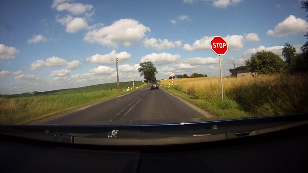 When approaching a level crossing in this situation, are you obliged to stop the vehicle before the STOP sign?