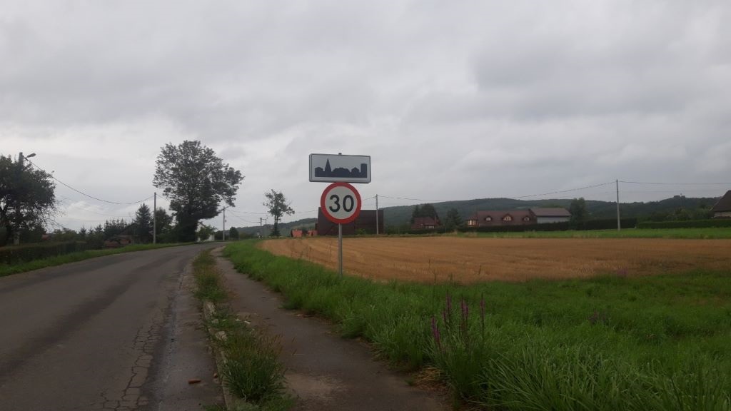 At what speed is a passenger car allowed to continue driving beyond these signs?